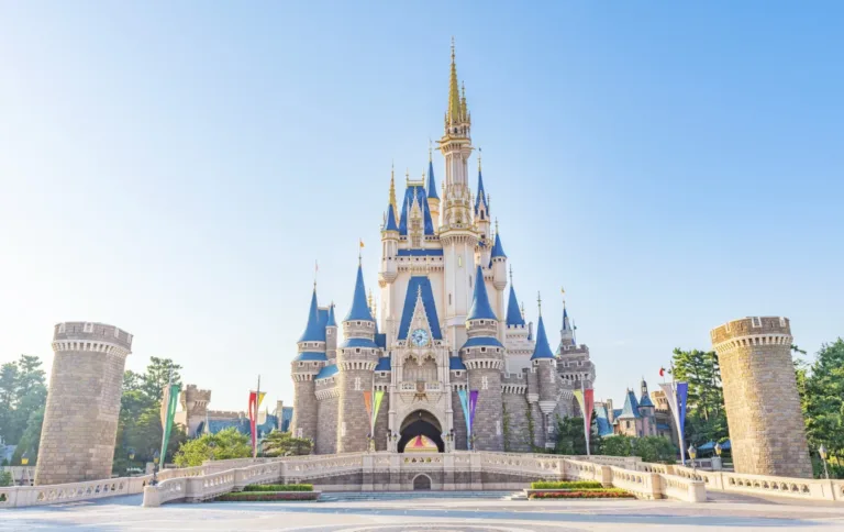 Enchanting fairytale castle with blue spires and stone walls, symbolizing magic and adventure at a theme park.