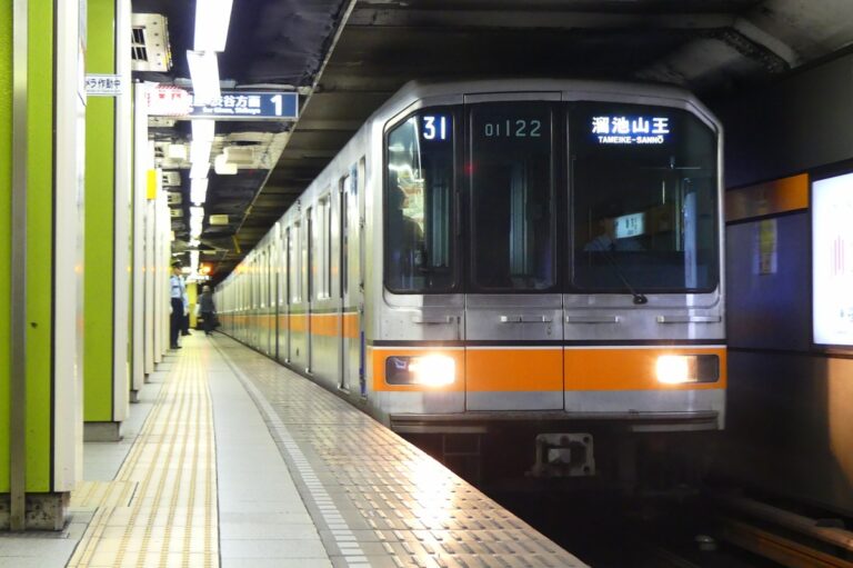 Tokyo subway train arriving at Tameike-Sanno station, showcasing urban transit and daily commuting in Japan.