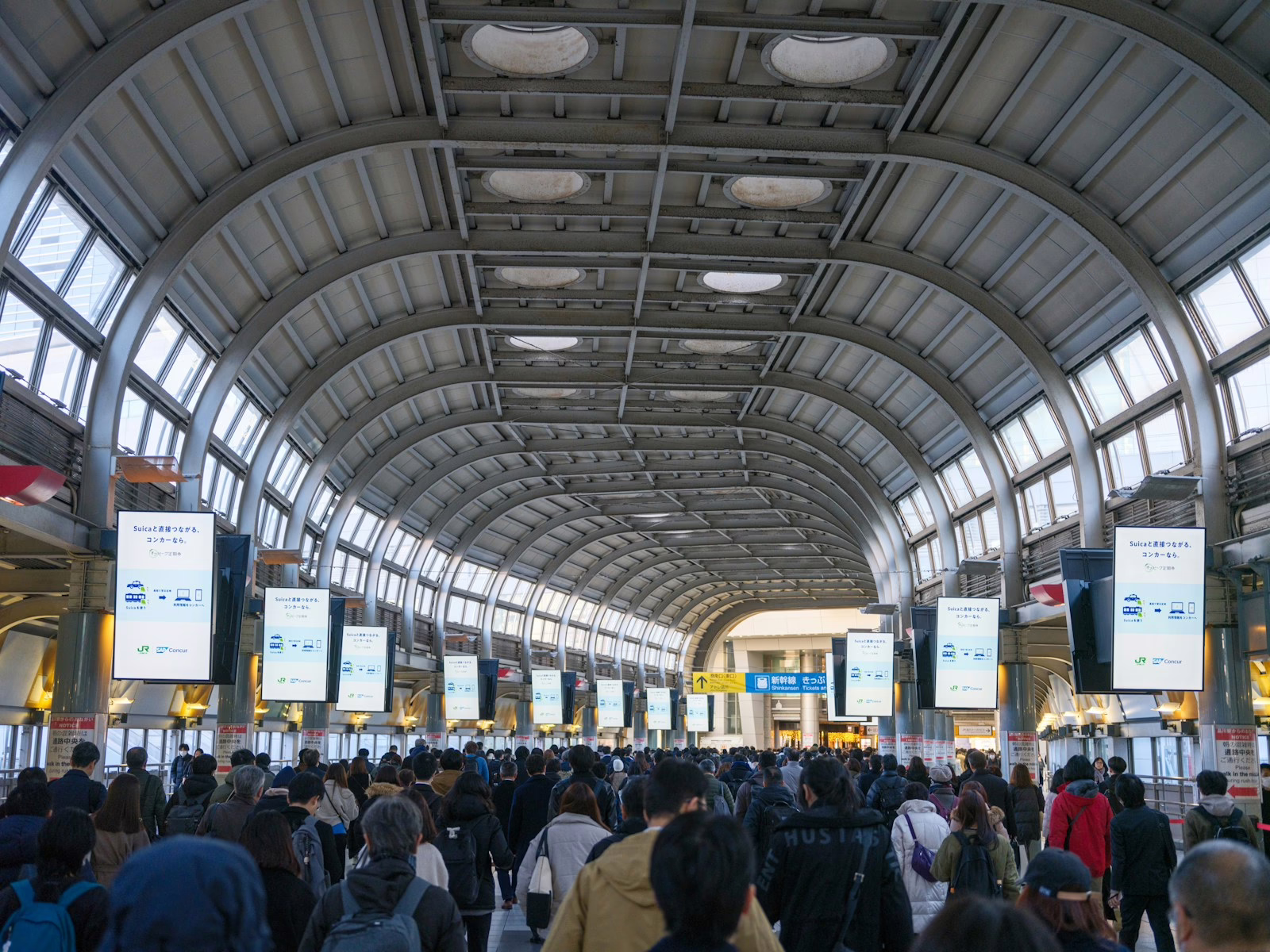 A large group of people walking through an airport
