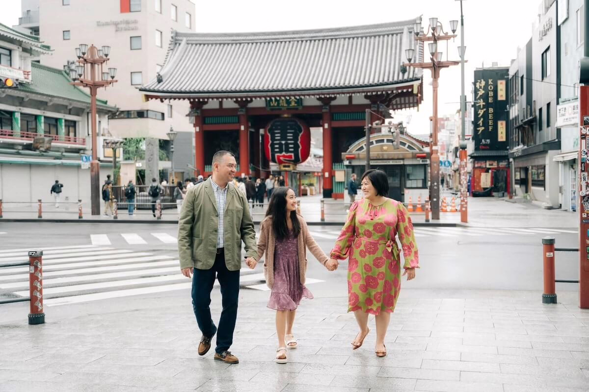 Family enjoying a stroll together near the iconic Senso-ji Temple in Asakusa, Tokyo, capturing a moment of connection and joy.