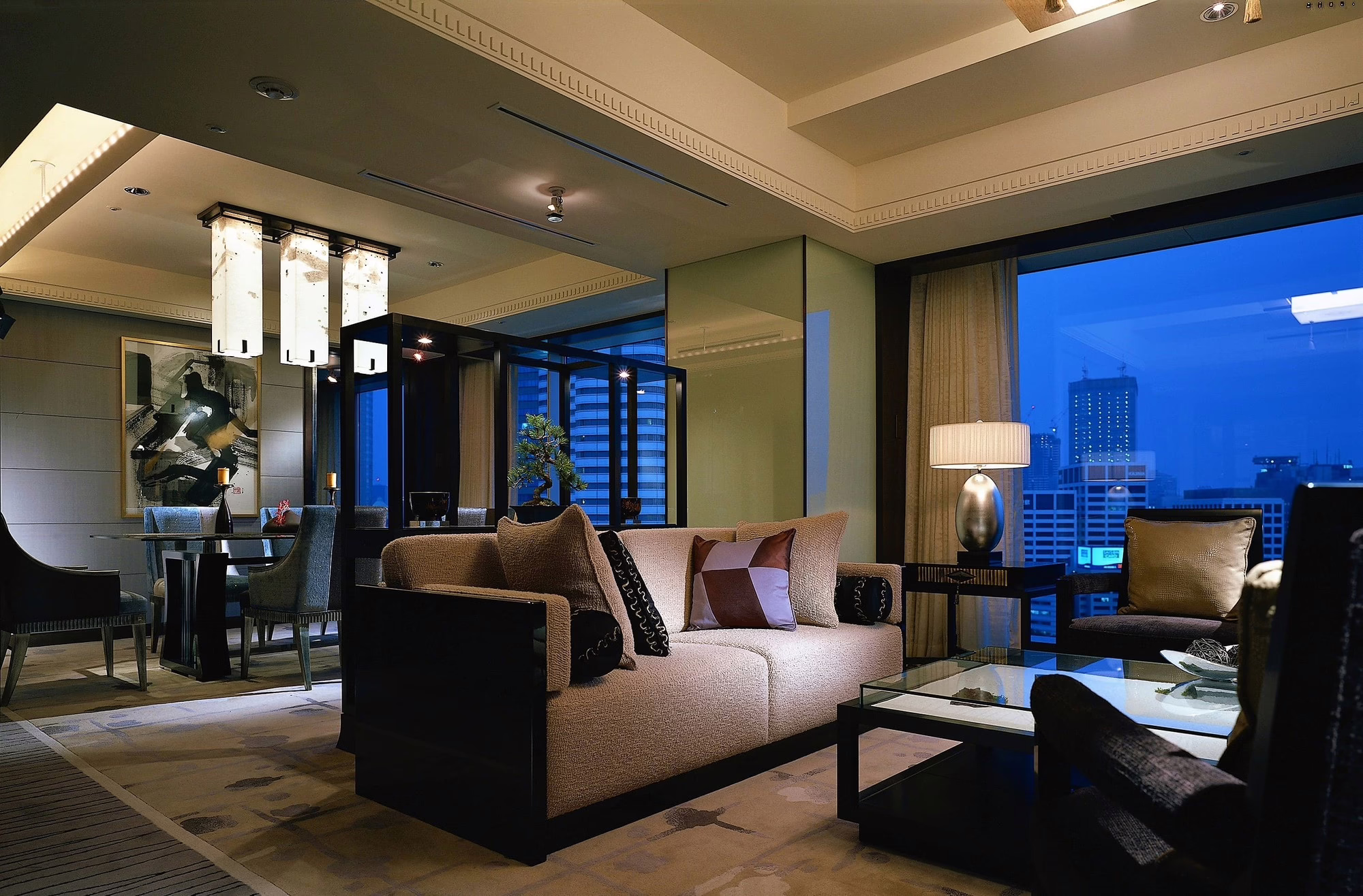 Sophisticated hotel suite featuring modern furnishings and city skyline views, ideal for luxury travel experiences.
