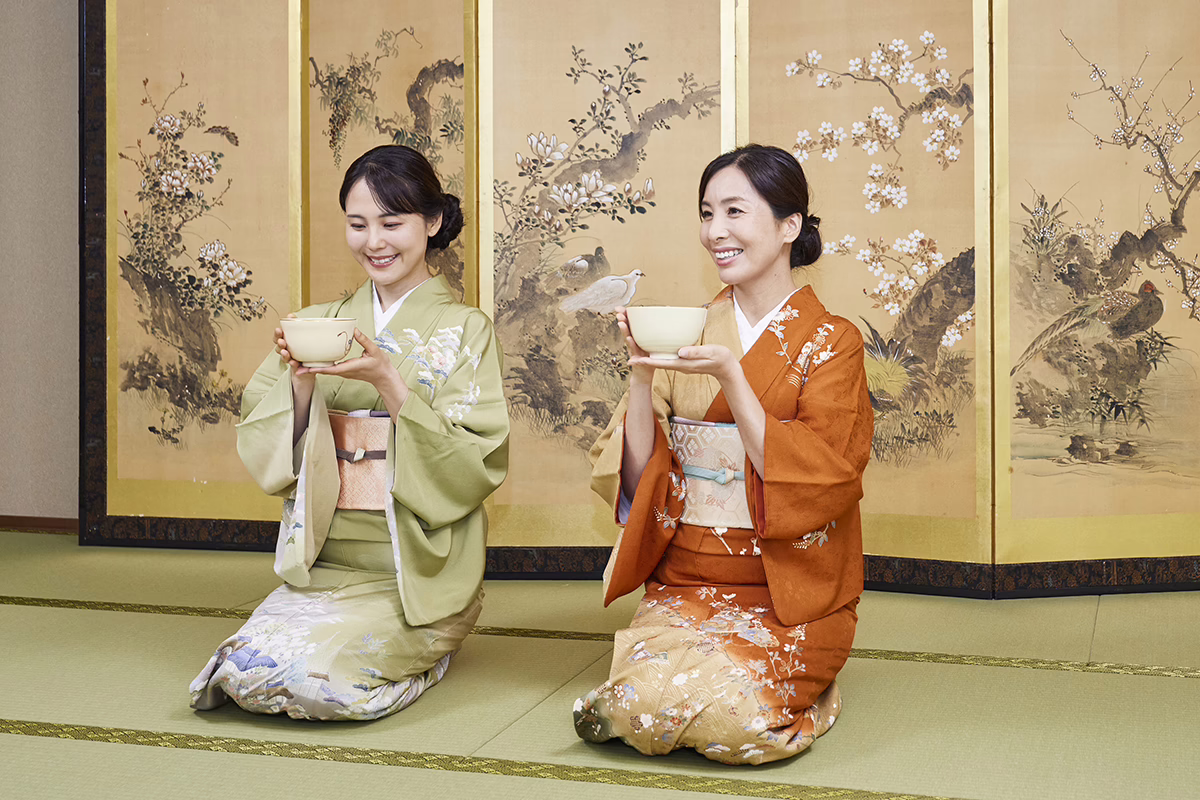 Women in traditional kimonos participate in a Japanese tea ceremony, showcasing cultural heritage and artistry.