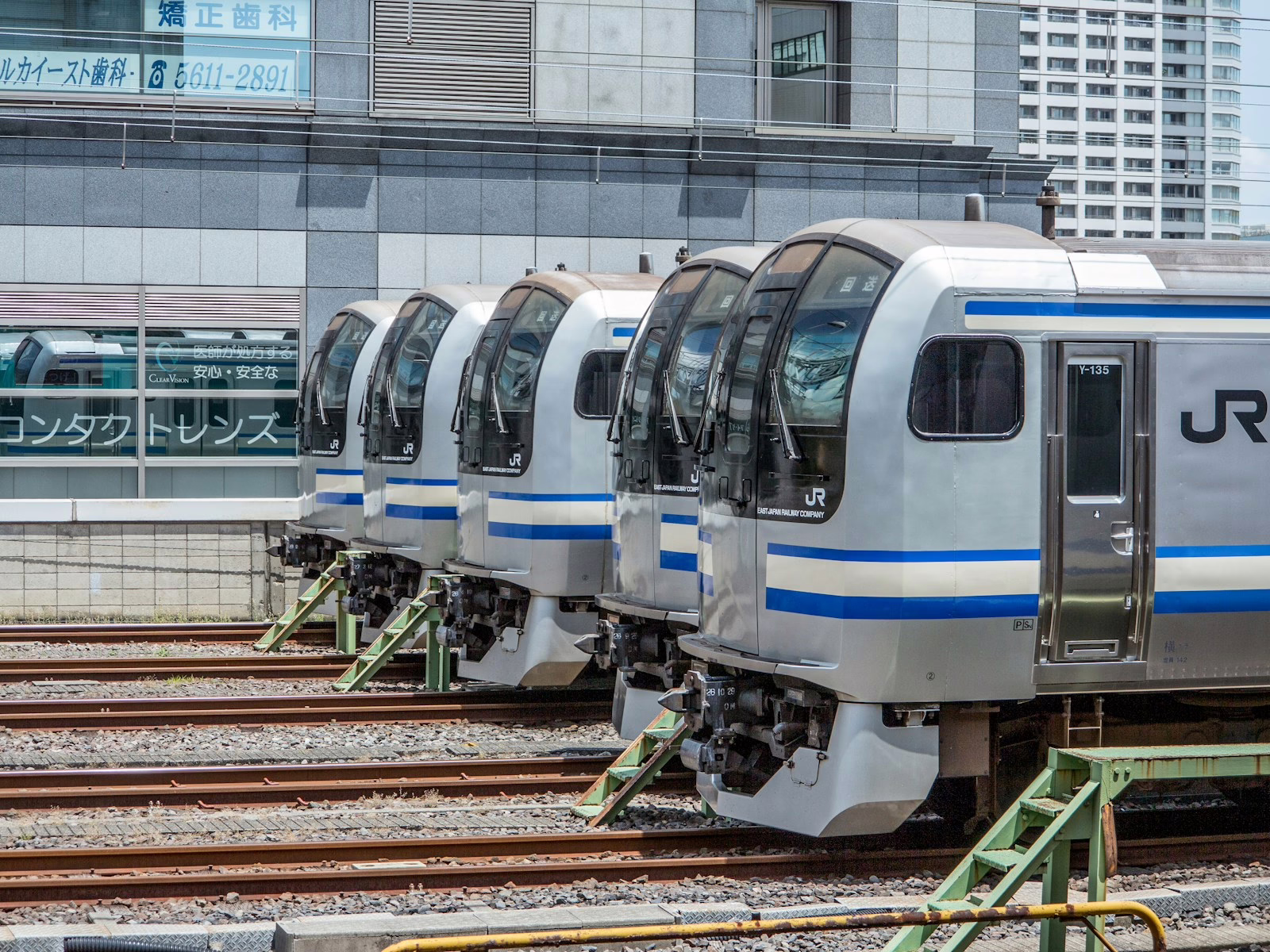 a row of train cars sitting on top of train tracks