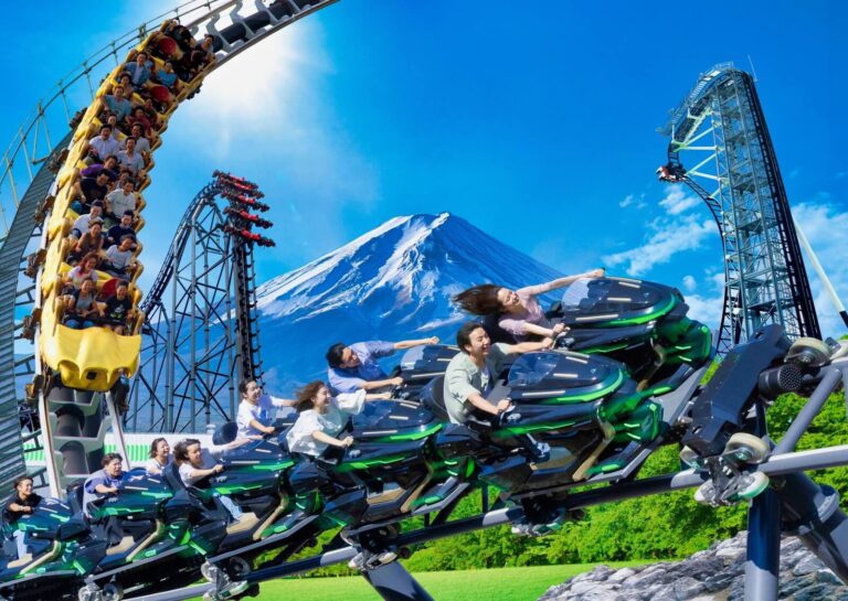 Thrilling roller coaster ride at Fuji-Q Highland with Mount Fuji in the background, capturing joy and excitement of escape.