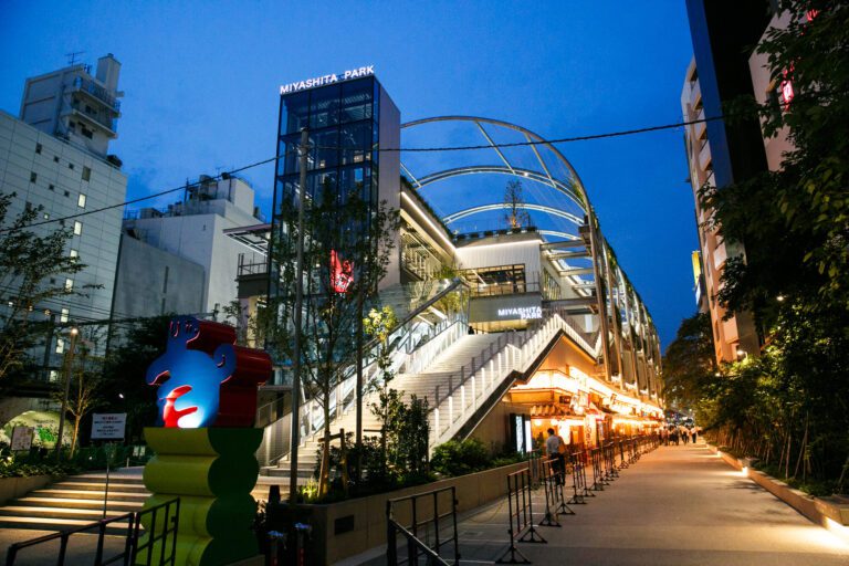 Vibrant evening scene at Miyashita Park showcasing modern architecture and lively pedestrian activity in Tokyo's urban landscape.